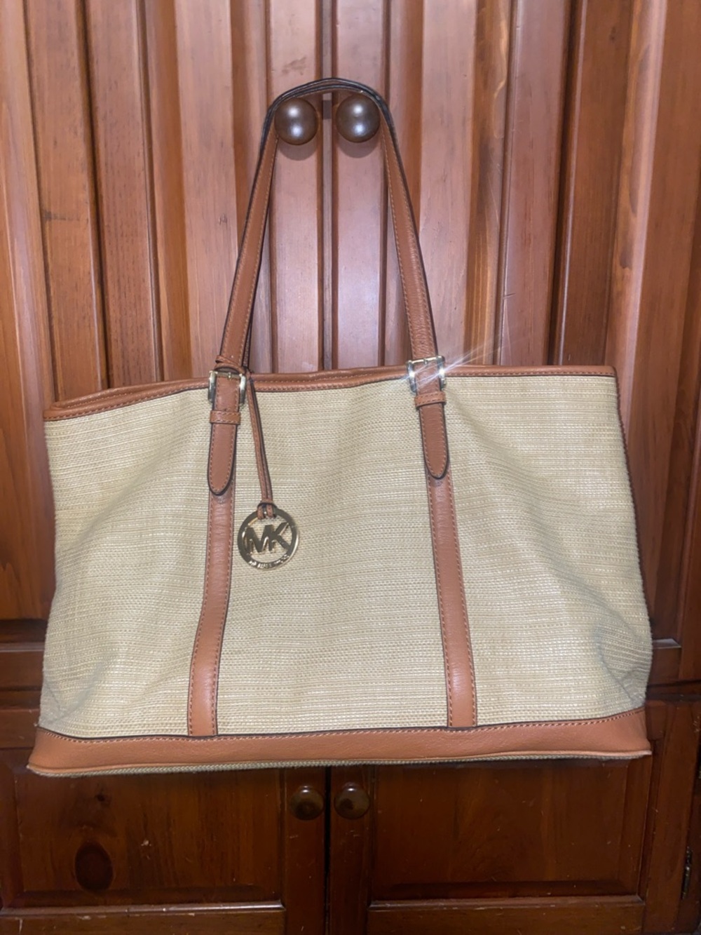 Michael Kors Raffia Tote with Tan Leather Trim and handles.